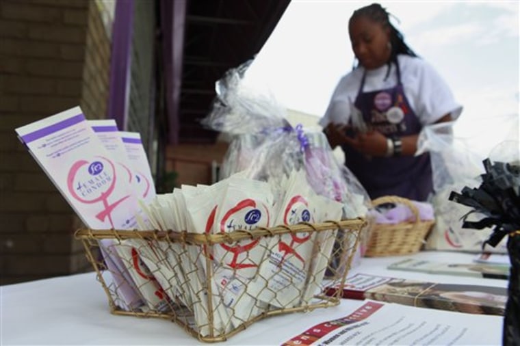 Charlene Cotton, of The Women's Collective in Washington D.C., staffs a table where she gives away female condoms on July 21, 2010. Community groups are handing out 500,000 of the female condoms during instruction sessions at beauty salons, barber shops, churches and restaurants.